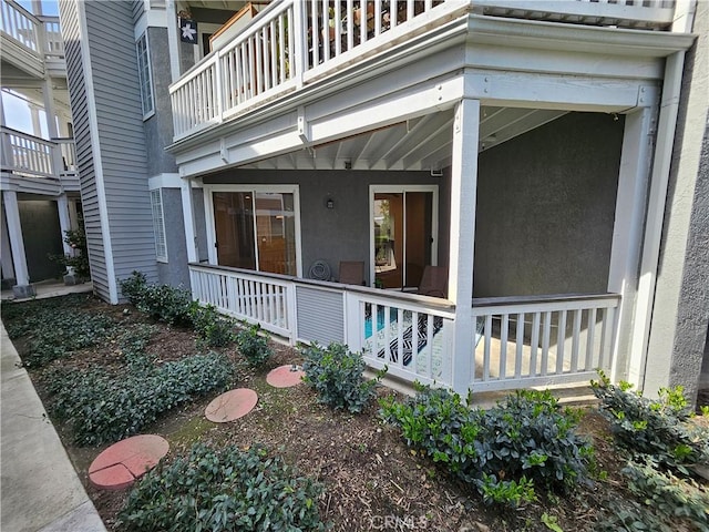 view of home's exterior with a balcony and stucco siding