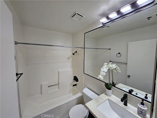 bathroom with washtub / shower combination, visible vents, vanity, and toilet