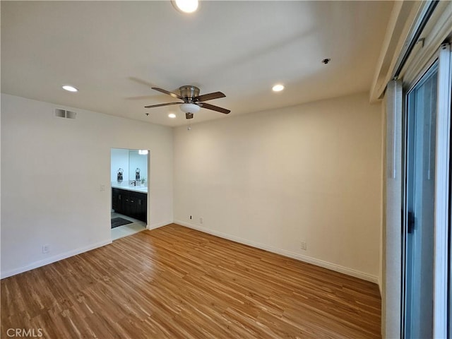 unfurnished room with recessed lighting, visible vents, baseboards, and wood finished floors