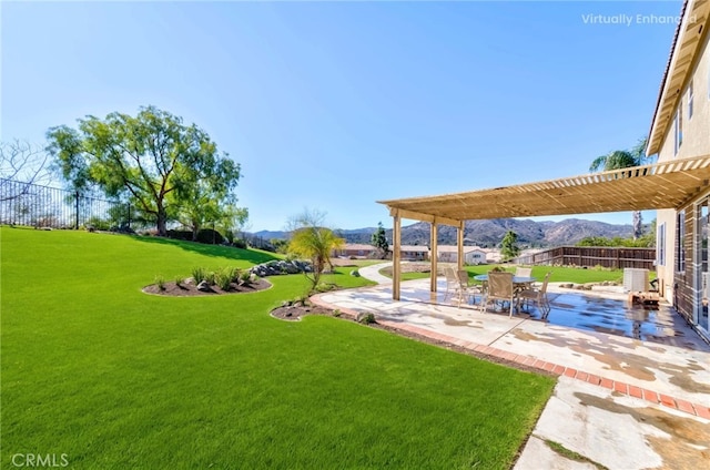 view of yard with a patio, fence private yard, a mountain view, and a pergola