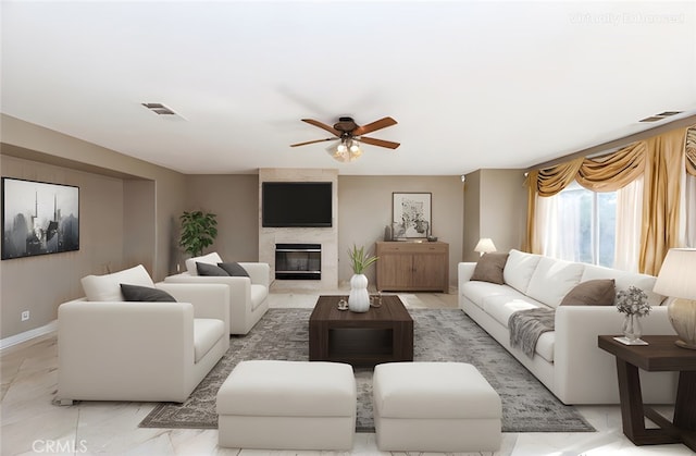 living room featuring baseboards, a high end fireplace, visible vents, and a ceiling fan