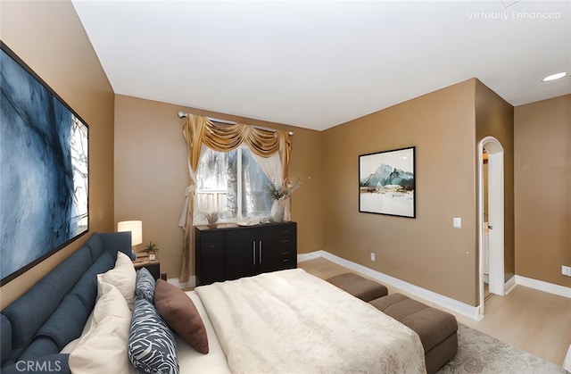 bedroom with baseboards and wood finished floors