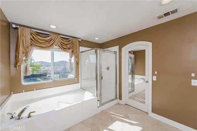 full bath featuring visible vents, a garden tub, tile patterned flooring, a shower stall, and a mountain view