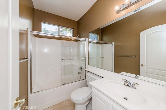 full bath with enclosed tub / shower combo, toilet, vanity, visible vents, and tile patterned floors