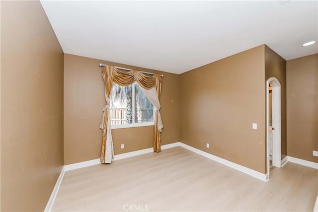 empty room with light wood-style flooring and baseboards