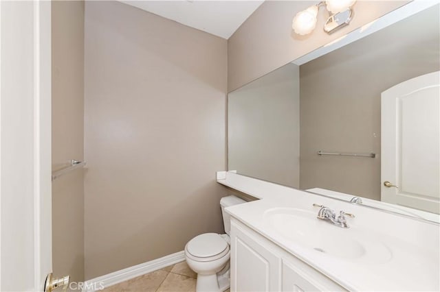 bathroom with toilet, tile patterned flooring, baseboards, and vanity