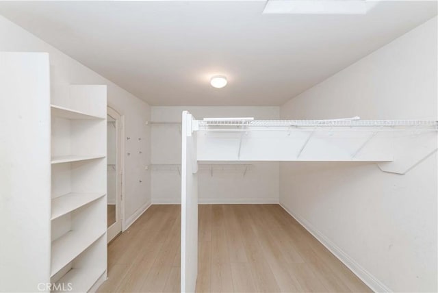 spacious closet featuring light wood-style flooring