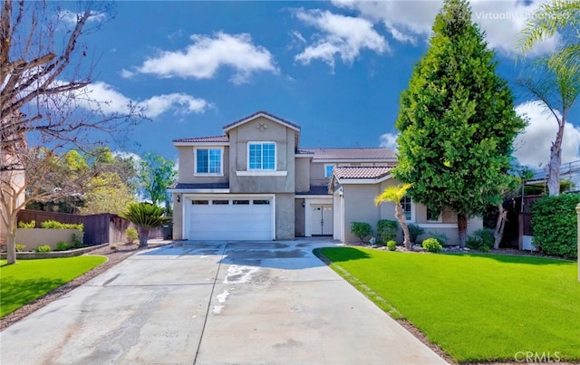 mediterranean / spanish-style house featuring stucco siding, an attached garage, a front yard, fence, and driveway