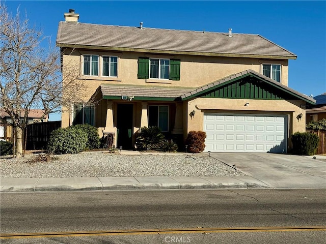 view of front of house with concrete driveway, a chimney, a tiled roof, an attached garage, and stucco siding