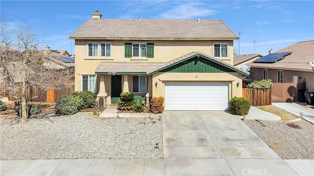 view of front of property with a tile roof, stucco siding, concrete driveway, fence, and a garage