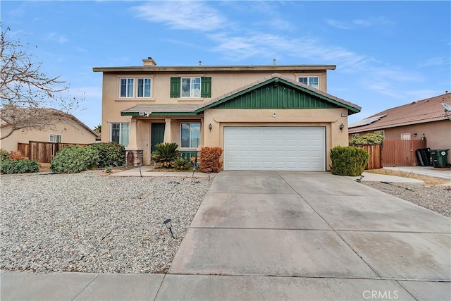 view of front of property with driveway, a garage, fence, and stucco siding