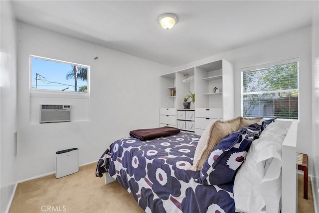 carpeted bedroom with an AC wall unit