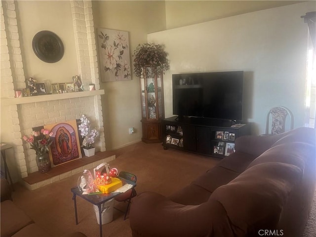 carpeted living area featuring a brick fireplace