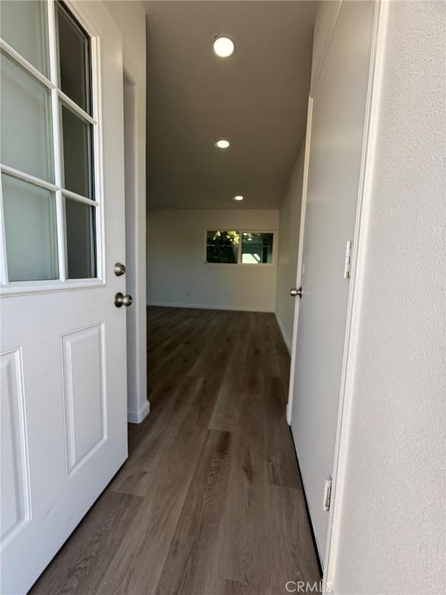 hall featuring recessed lighting and dark wood finished floors