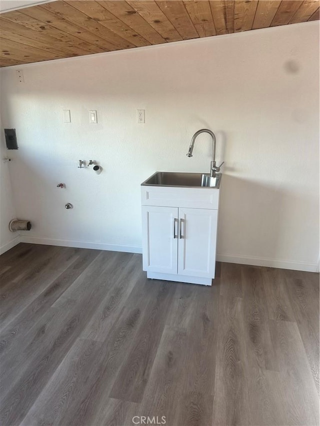 washroom with dark wood-type flooring, a sink, wood ceiling, and baseboards