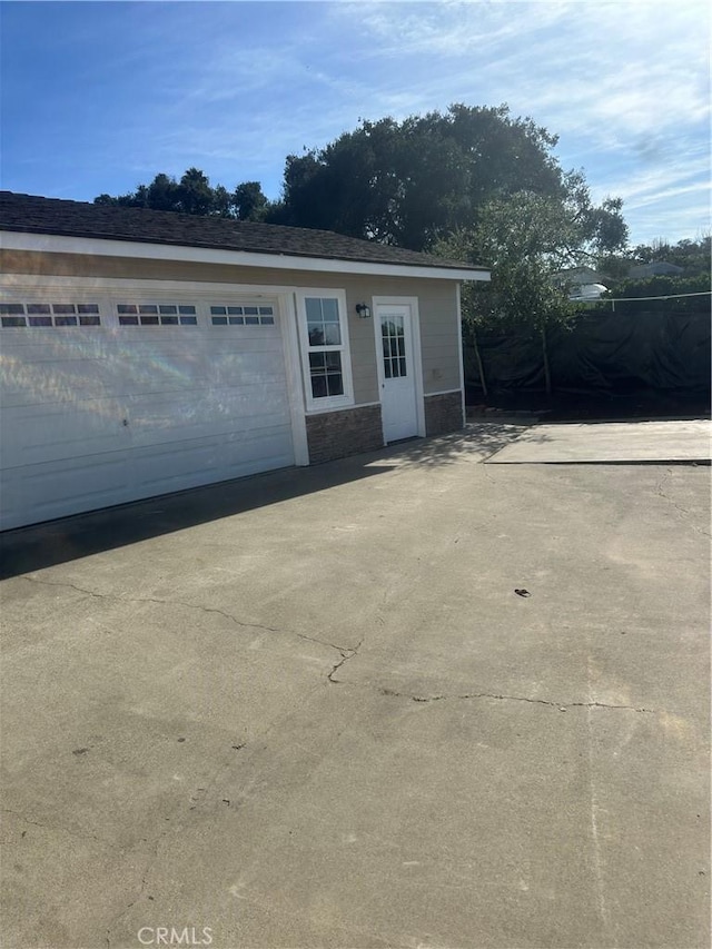 view of front of property featuring an outbuilding and a garage