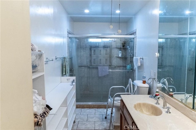 full bathroom with vanity, a shower stall, and tile patterned floors