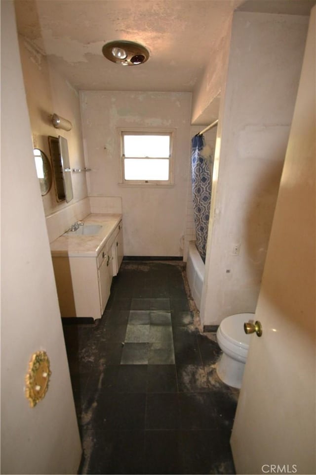 full bath featuring toilet, shower / tub combo with curtain, and vanity