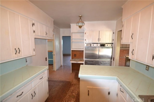 kitchen with a peninsula and white cabinets