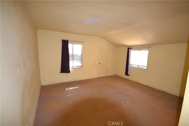 additional living space featuring lofted ceiling