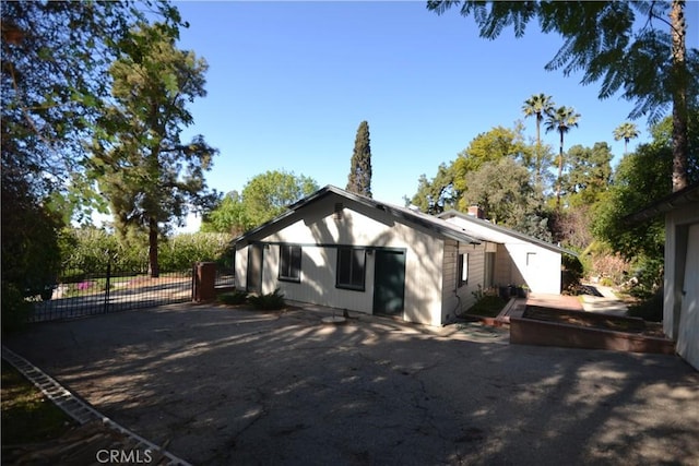 rear view of house featuring fence