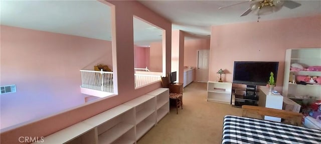 living room featuring ceiling fan, visible vents, and light colored carpet