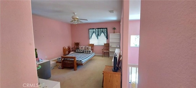 carpeted bedroom with visible vents and a ceiling fan