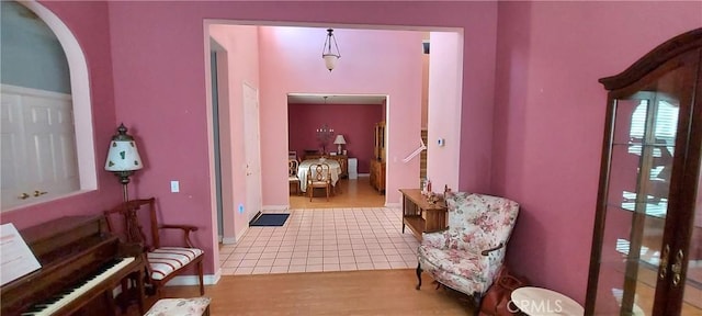 interior space with arched walkways and wood finished floors