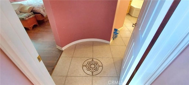 hall with tile patterned floors