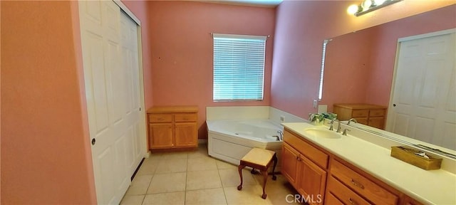 full bath featuring tile patterned flooring, a closet, a garden tub, and vanity