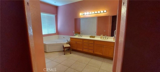 full bathroom featuring tile patterned flooring, a garden tub, a sink, and double vanity