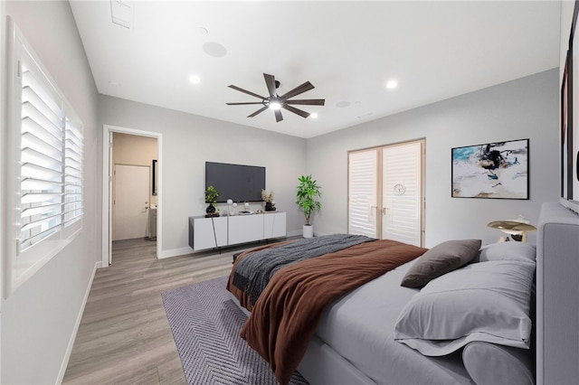 bedroom featuring ceiling fan, light wood finished floors, recessed lighting, and baseboards