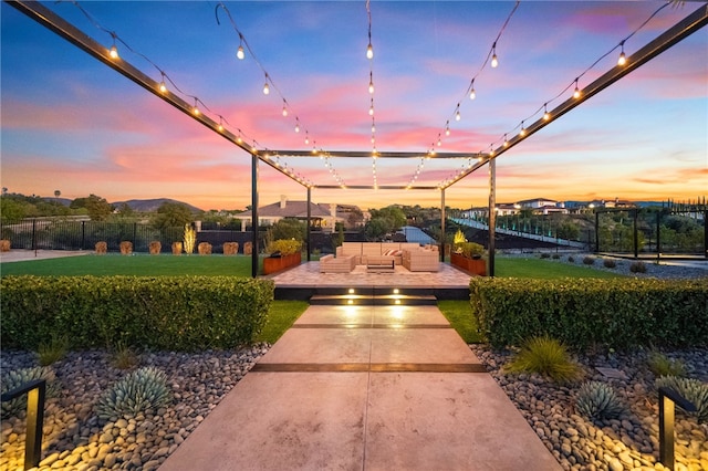 view of home's community featuring a mountain view, fence, outdoor lounge area, and a yard