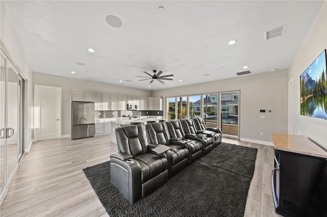 living area featuring light wood-style flooring, visible vents, baseboards, and recessed lighting