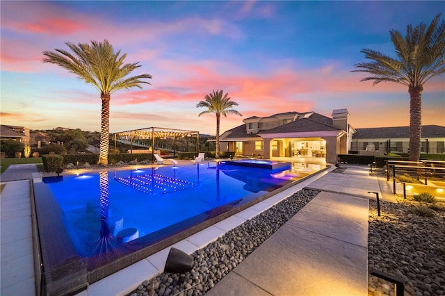 view of swimming pool with a patio area and a pool with connected hot tub