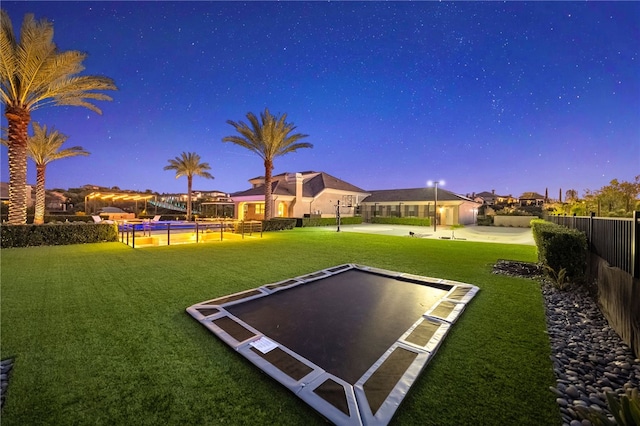 view of home's community featuring fence and a lawn