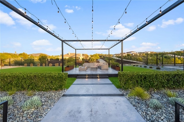 view of community with fence, an outdoor living space, and a yard