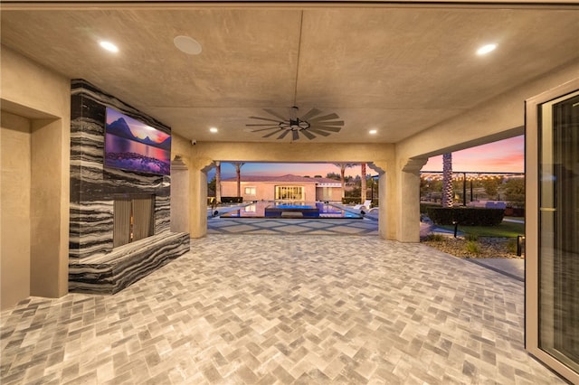 interior space featuring a ceiling fan, a sunroom, and recessed lighting