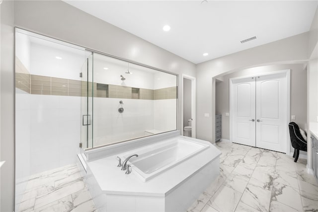 bathroom with toilet, visible vents, marble finish floor, a bath, and a stall shower