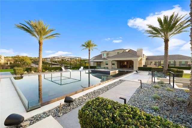 view of property's community with a pool and a patio