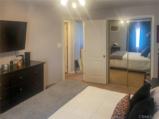 carpeted bedroom with an AC wall unit and a closet