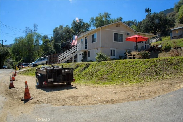 view of side of home featuring stairway