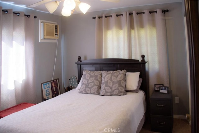 bedroom featuring an AC wall unit and ceiling fan