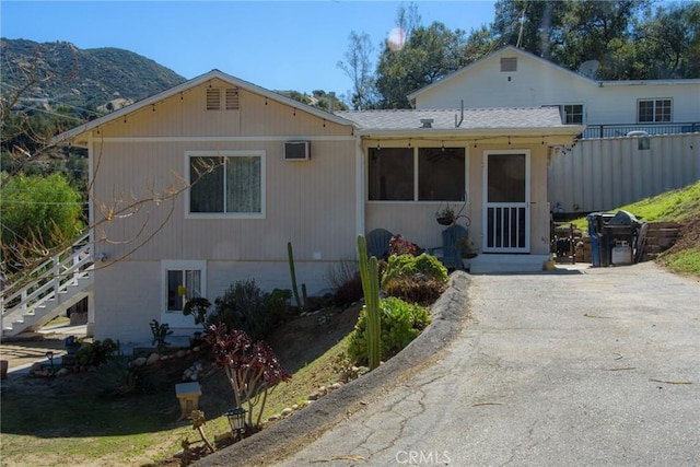 view of front of property with stairs and a mountain view