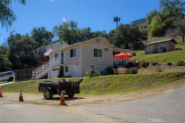 view of front facade with stairs and driveway