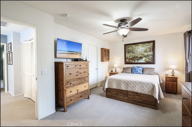 bedroom featuring light carpet, baseboards, and a ceiling fan