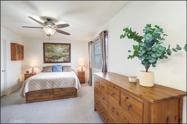 bedroom with light carpet and ceiling fan