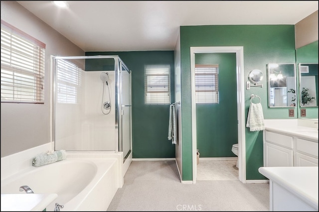 full bathroom featuring toilet, vanity, baseboards, a bath, and a stall shower