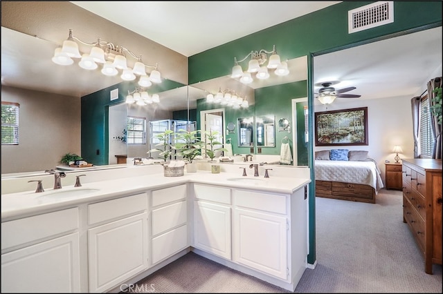 ensuite bathroom featuring a healthy amount of sunlight, visible vents, a sink, and ensuite bath