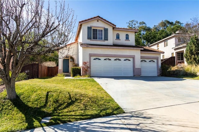 mediterranean / spanish-style house featuring stucco siding, a front yard, fence, driveway, and a tiled roof